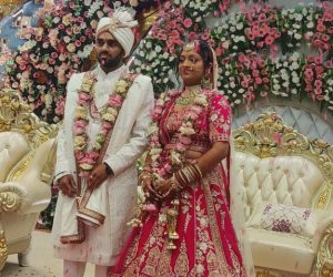 Traditional wedding attire with rose petal shower.