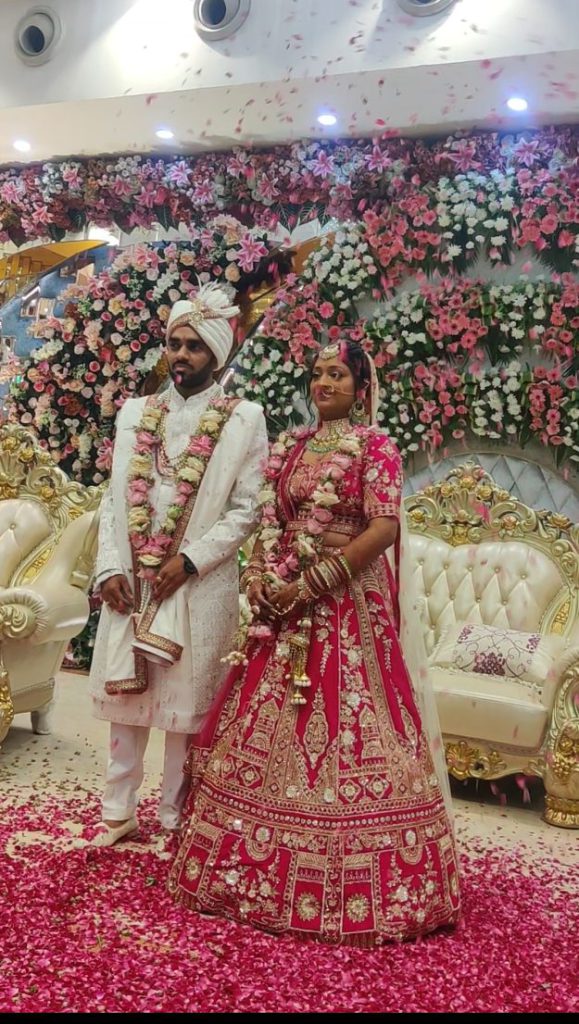 Traditional wedding attire with rose petal shower.