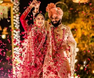 Traditional wedding attire with rose petal shower.