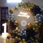 1st Anniversary Ring Balloon Decoration Package featuring 130 gold, black, and silver balloons with neon “Happy Anniversary” light by Dream Spark Events