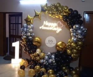 1st Anniversary Ring Balloon Decoration Package featuring 130 gold, black, and silver balloons with neon “Happy Anniversary” light by Dream Spark Events