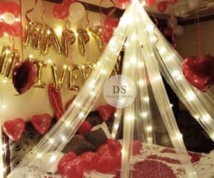 Luxury Cabana Anniversary Room Decoration Package featuring fairy lights, heart balloons, and cabana canopy by Dream Spark Events