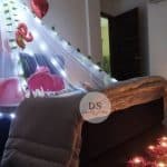 Cabana Room Decoration in Delhi NCR with fairy lights, heart balloons, and rose petals by Dream Spark Events
