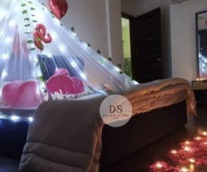 Cabana Room Decoration in Delhi NCR with fairy lights, heart balloons, and rose petals by Dream Spark Events