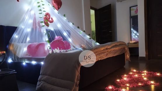 Cabana Room Decoration in Delhi NCR with fairy lights, heart balloons, and rose petals by Dream Spark Events