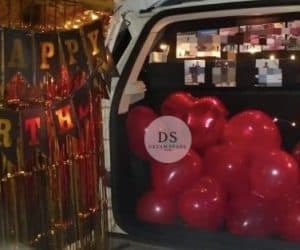 Luxury Car Dikki Surprise Decoration in Delhi NCR with red balloons and fairy lights by Dream Spark Events