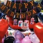 Premium Car Trunk Surprise Decoration in Delhi NCR with red and pink balloons, foil stars, and photo hangings by Dream Spark Events