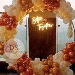 Romantic balloon decoration with 75 white, blush pink, and champagne gold balloons arranged in an elegant arch and ring setup by Dream Spark Events
