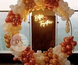Romantic balloon decoration with 75 white, blush pink, and champagne gold balloons arranged in an elegant arch and ring setup by Dream Spark Events