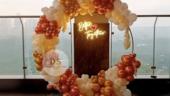 Romantic balloon decoration with 75 white, blush pink, and champagne gold balloons arranged in an elegant arch and ring setup by Dream Spark Events
