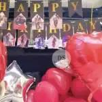Car Boot Birthday Decoration in Delhi NCR with red balloons, foil hearts, and personalized photo banner by Dream Spark Events