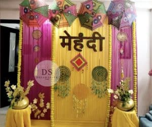 Golden Mehndi Night Decoration package with floral garlands and shimmer backdrop by Dream Spark Events