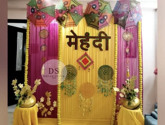 Golden Mehndi Night Decoration package with floral garlands and shimmer backdrop by Dream Spark Events