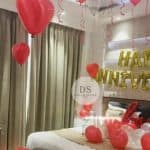 Romantic Anniversary Room Decoration Package featuring red heart balloons and golden Happy Anniversary backdrop by Dream Spark Events