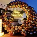 Beautiful First Anniversary Decoration in Delhi NCR featuring gold and silver balloon ring with neon light signage by Dream Spark Events