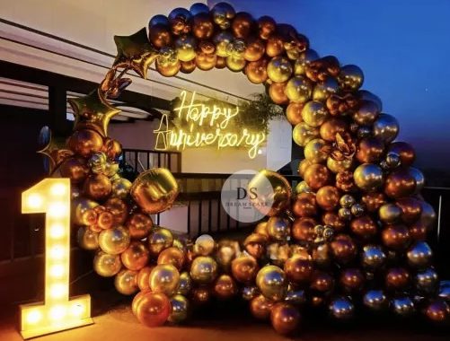 Beautiful First Anniversary Decoration in Delhi NCR featuring gold and silver balloon ring with neon light signage by Dream Spark Events
